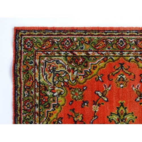698 - Carpet / Rug : A red ground red decorated with a central vignette with floral and foliate detail. Ap... 