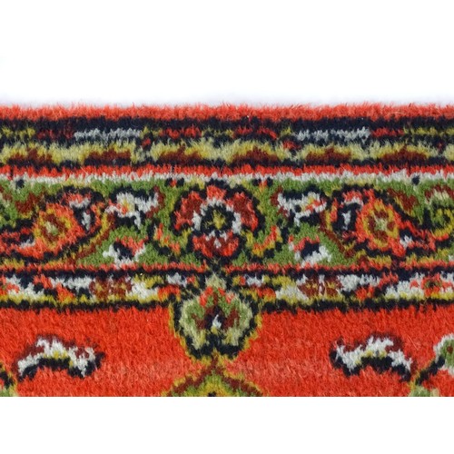 698 - Carpet / Rug : A red ground red decorated with a central vignette with floral and foliate detail. Ap... 