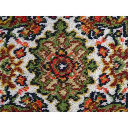 698 - Carpet / Rug : A red ground red decorated with a central vignette with floral and foliate detail. Ap... 