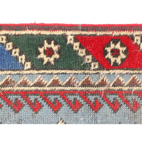 699 - Carpet / Rug : A pale blue ground runner decorated with repeating geometric motifs and banded border... 