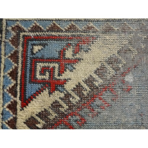 699 - Carpet / Rug : A pale blue ground runner decorated with repeating geometric motifs and banded border... 
