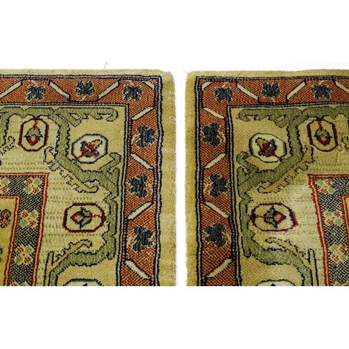 706 - Carpet / Rug  : Two runners with banded motifs to the central ochre coloured ground bordered by flor... 