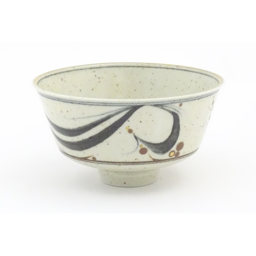 709 - A studio pottery footed bowl with brushwork detail by Derek Clarkson (1928-2013). Makers mark to foo... 