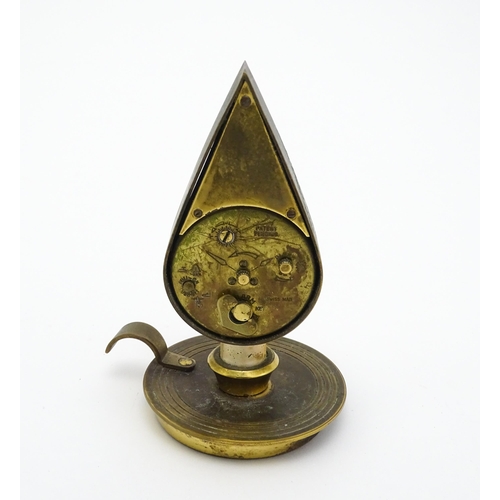 711 - A Swiza novelty clock formed as a chamber stick with candle, the clock of flame form.  Approx 5 1/4