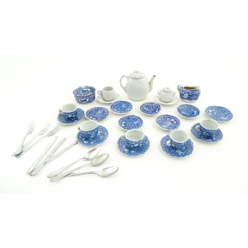 712 - A quantity of blue and white miniature tea wares to include milk jug, sugar bowl, cups and saucers. ... 