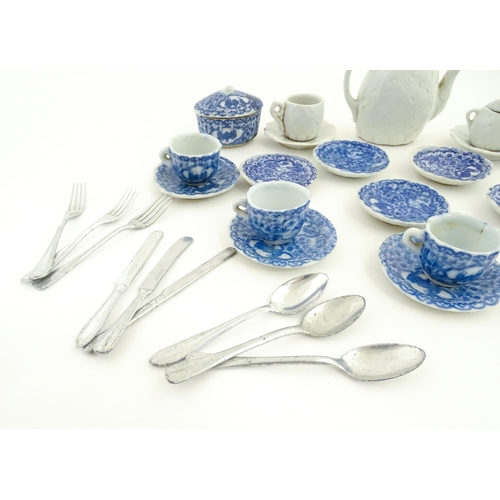 712 - A quantity of blue and white miniature tea wares to include milk jug, sugar bowl, cups and saucers. ... 