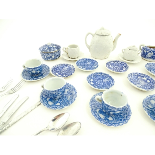 712 - A quantity of blue and white miniature tea wares to include milk jug, sugar bowl, cups and saucers. ... 