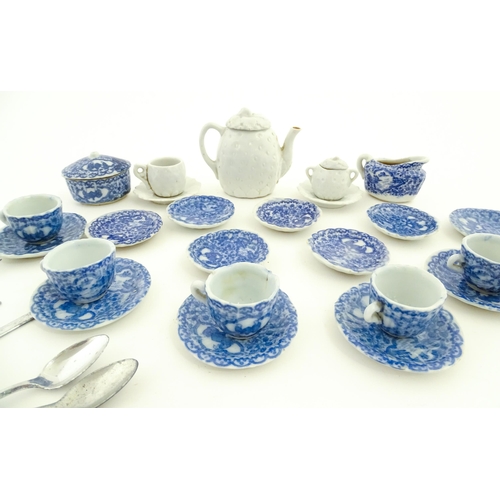 712 - A quantity of blue and white miniature tea wares to include milk jug, sugar bowl, cups and saucers. ... 