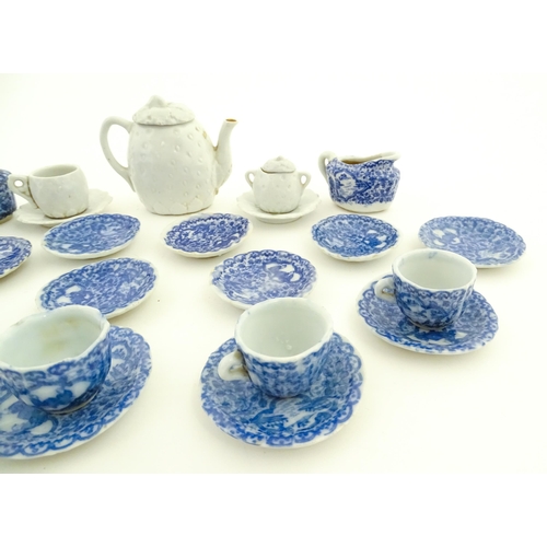 712 - A quantity of blue and white miniature tea wares to include milk jug, sugar bowl, cups and saucers. ... 