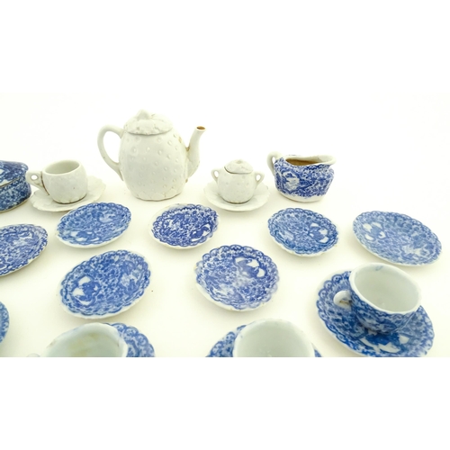 712 - A quantity of blue and white miniature tea wares to include milk jug, sugar bowl, cups and saucers. ... 