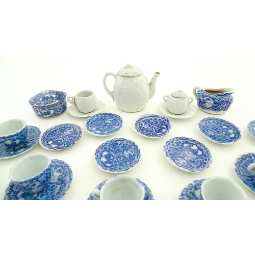 712 - A quantity of blue and white miniature tea wares to include milk jug, sugar bowl, cups and saucers. ... 