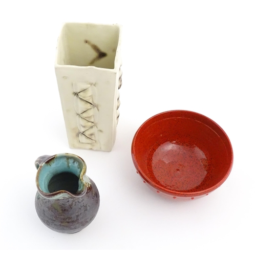 714 - Three items of studio pottery comprising a slab vase with incised decoration by Roger Lewis, a jug w... 