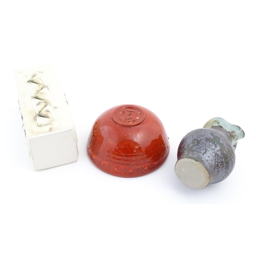 714 - Three items of studio pottery comprising a slab vase with incised decoration by Roger Lewis, a jug w... 