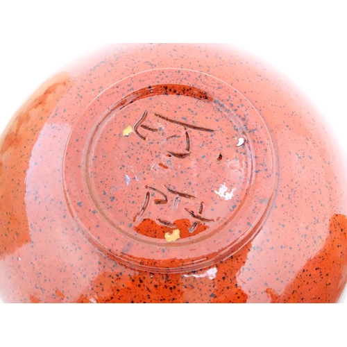 714 - Three items of studio pottery comprising a slab vase with incised decoration by Roger Lewis, a jug w... 