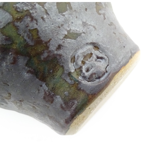 714 - Three items of studio pottery comprising a slab vase with incised decoration by Roger Lewis, a jug w... 