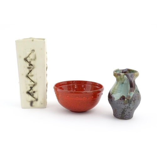 714 - Three items of studio pottery comprising a slab vase with incised decoration by Roger Lewis, a jug w... 