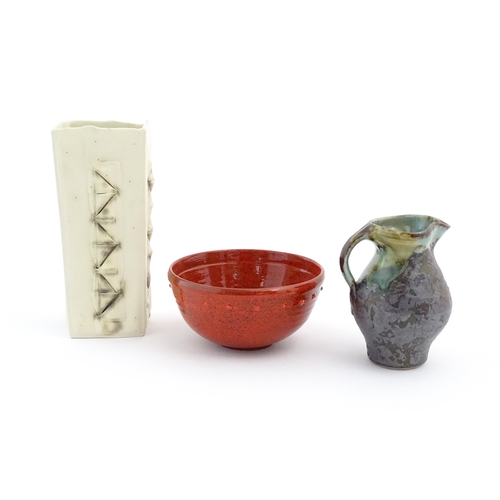 714 - Three items of studio pottery comprising a slab vase with incised decoration by Roger Lewis, a jug w... 