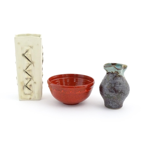 714 - Three items of studio pottery comprising a slab vase with incised decoration by Roger Lewis, a jug w... 