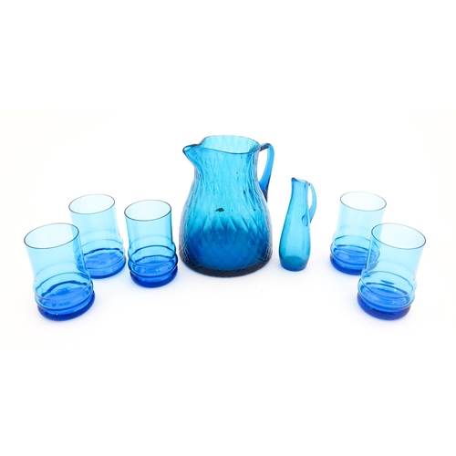 725 - A quantity of turquoise glass to include jugs, glasses etc. Largest jug approx. 7 3/4