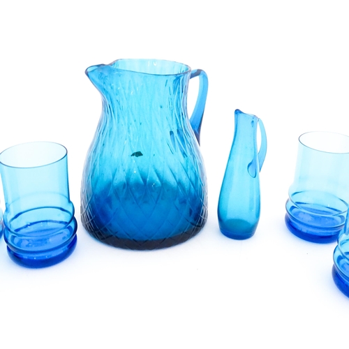 725 - A quantity of turquoise glass to include jugs, glasses etc. Largest jug approx. 7 3/4