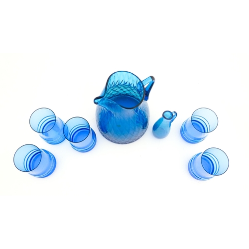 725 - A quantity of turquoise glass to include jugs, glasses etc. Largest jug approx. 7 3/4