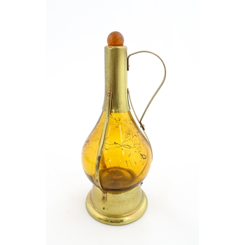 779 - A 20thC amber glass musical decanter with metal mounts. Approx. 11 1/2