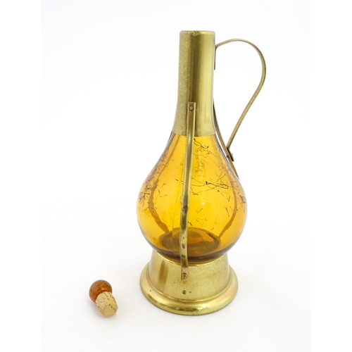 779 - A 20thC amber glass musical decanter with metal mounts. Approx. 11 1/2