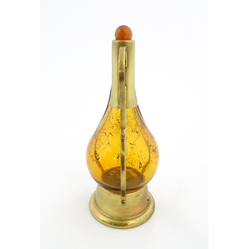 779 - A 20thC amber glass musical decanter with metal mounts. Approx. 11 1/2