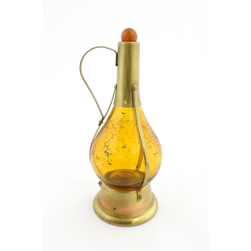 779 - A 20thC amber glass musical decanter with metal mounts. Approx. 11 1/2