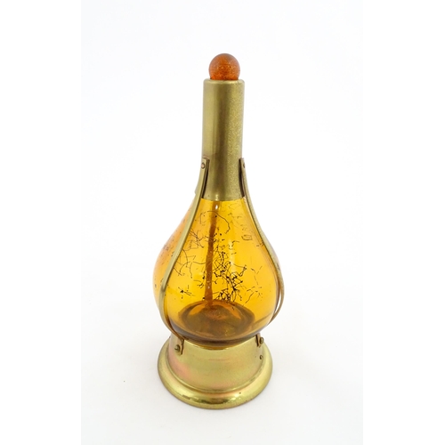 779 - A 20thC amber glass musical decanter with metal mounts. Approx. 11 1/2