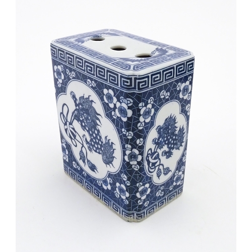 782 - A Chinese blue and white flower brick decorated with foo dogs within vignettes bordered by prunus fl... 