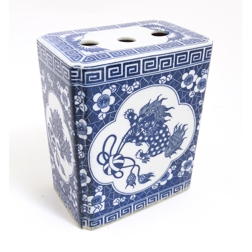 782 - A Chinese blue and white flower brick decorated with foo dogs within vignettes bordered by prunus fl... 