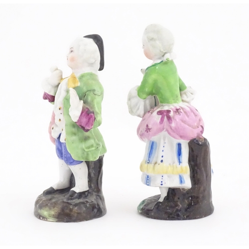 822 - Two Continental ceramic figures, depicting a Regency gentleman and a young lady. One indistinctly ma... 