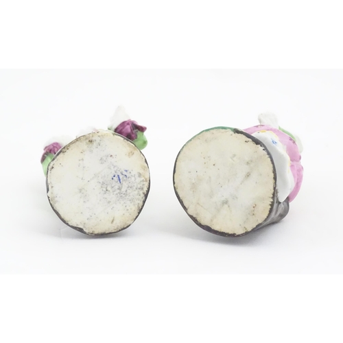 822 - Two Continental ceramic figures, depicting a Regency gentleman and a young lady. One indistinctly ma... 