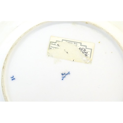 823 - A Meissen style blue and white plate decorated in the Onion pattern. Crossed sword mark under. Appro... 