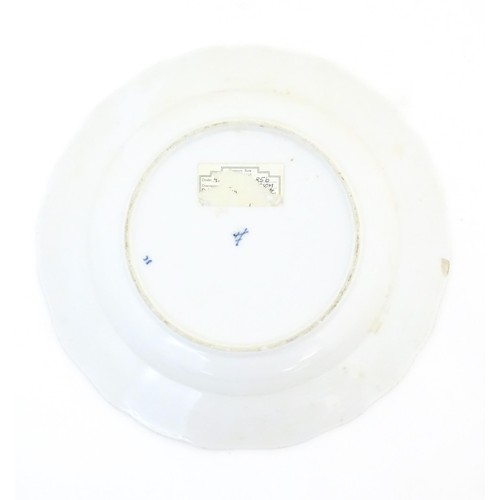 823 - A Meissen style blue and white plate decorated in the Onion pattern. Crossed sword mark under. Appro... 