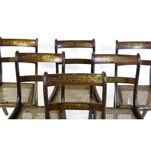827 - A set of six 19thC brass inlaid dining chairs, with caned seats and drop in seats raised on sabre le... 