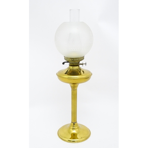 836 - A brass oil lamp with column detail and spherical shade. Approx. 28 1/2