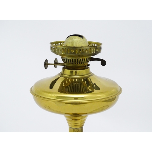 836 - A brass oil lamp with column detail and spherical shade. Approx. 28 1/2