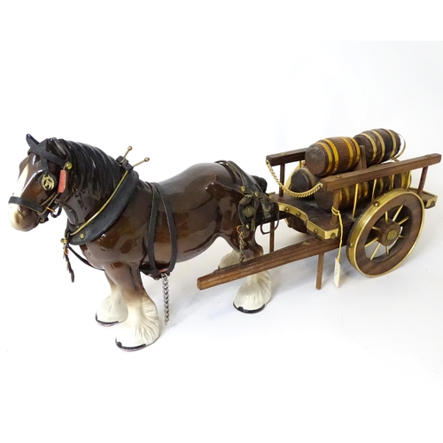 853 - A ceramic model of a dray horse with a wooden cart and barrels. Horse approx. 13 1/2