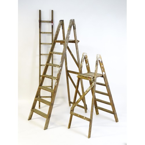 855 - Two A-frame platform ladders together with a straight ladder, the largest approx 82