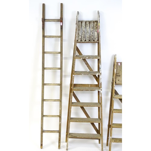 855 - Two A-frame platform ladders together with a straight ladder, the largest approx 82