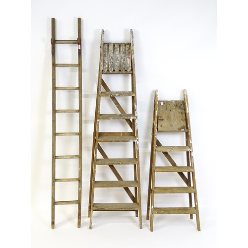 855 - Two A-frame platform ladders together with a straight ladder, the largest approx 82