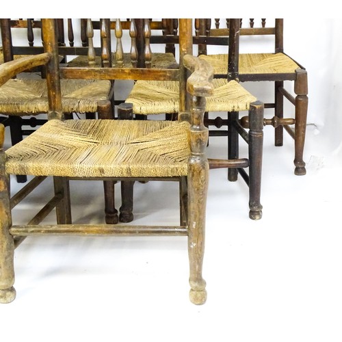 869 - A group of twelve 19thC spindle back dining chairs. Th largest 23