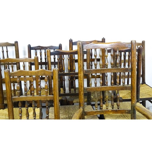 869 - A group of twelve 19thC spindle back dining chairs. Th largest 23