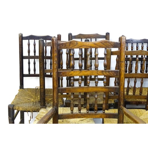 869 - A group of twelve 19thC spindle back dining chairs. Th largest 23