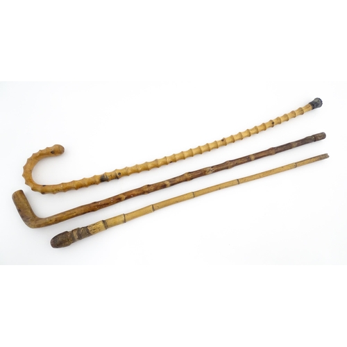 874 - Three assorted walking sticks / canes to include an example with Oriental character marks and scene.... 