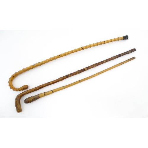 874 - Three assorted walking sticks / canes to include an example with Oriental character marks and scene.... 