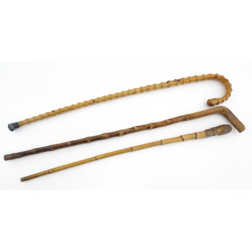 874 - Three assorted walking sticks / canes to include an example with Oriental character marks and scene.... 