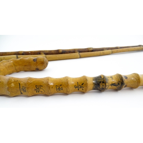 874 - Three assorted walking sticks / canes to include an example with Oriental character marks and scene.... 